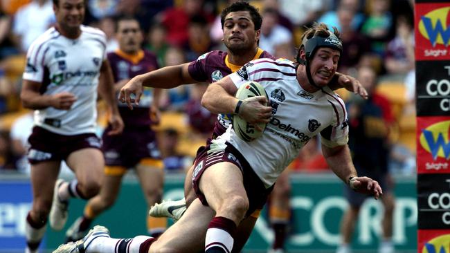 NRL.Round 9.Brisbane Broncos v Manly Sea Eagles at Suncorp Stadium.Steve Menzies beats the grasping tackle of Karmichael Hunt to score during Manly's victory 30-12.