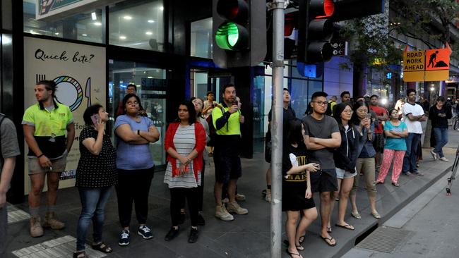 Residents of the Spencer St tower wait across the road at Southern Cross station during the emergency. Picture: Andrew Henshaw