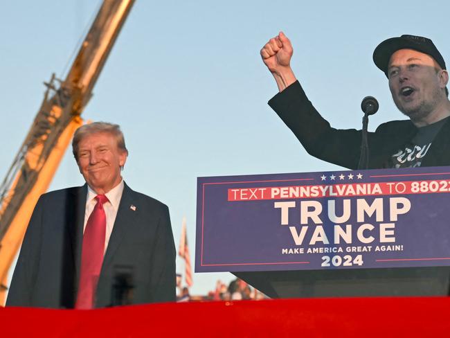 (FILES) Tesla CEO Elon Musk (R) speaks on stage as he joins former US President and Republican presidential candidate Donald Trump during a campaign rally at site of his first assassination attempt in Butler, Pennsylvania on October 5, 2024. Donald Trump announced Nvember 12, 2024 that the world's richest man, Elon Musk, will lead a new US government efficiency group tasked with cutting federal waste, as the Republican president-elect added a series of seasoned figures and hardliners to his incoming administration. Musk became a key ally to Trump during his campaign, reportedly spending over $100 million to help the Republican win and repeatedly boosting Trump's candidacy on X, the platform he owns. (Photo by Jim WATSON / AFP)