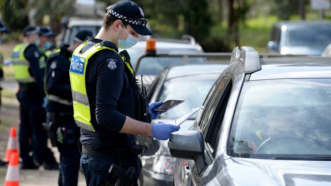 Police check travel permits at a mobile checkpoint at Eltham in Melbourne. Picture: NCA NewsWire / Andrew Henshaw