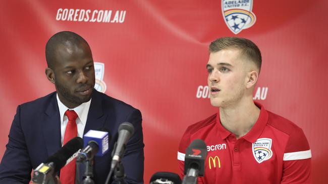 Adelaide United's football director Bruce Djite with Riley McGree in July. Picture Dean Martin