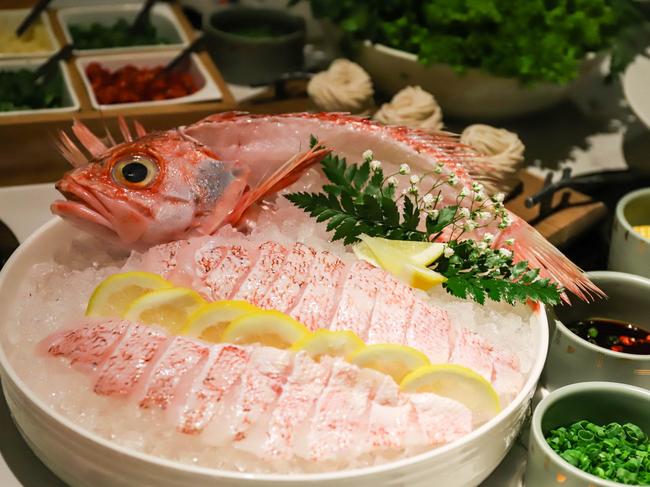 A whole fish to on the table with the hotpot. Picture: Jenifer Jagielski