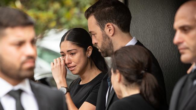 Tony Plati’s daughter Maria, centre, with her partner Tom Roberts, outside St Kevin’s Catholic Church, Dee Why. Picture: Julian Andrews