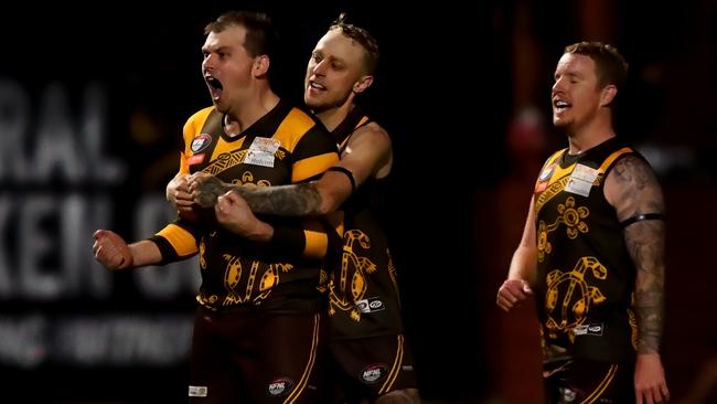 Heidelberg West players celebrate a goal.