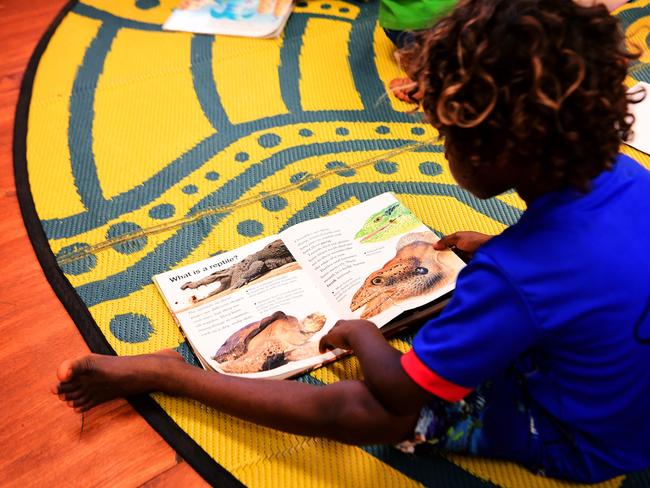 Minyerri School’s Year 2-3 students read books during Thursday's class. The Minyerri community is located some 480km from Darwin. Picture: Justin Kennedy