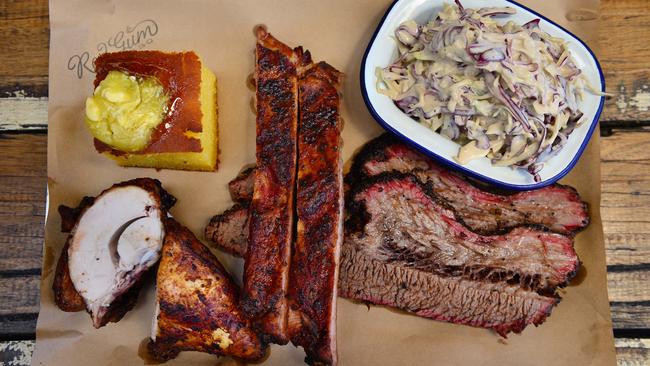 Red Gum BBQ’s tray, with chicken quarter, beef brisket, pork rib, coleslaw and cornbread. Picture: Nicki Connolly