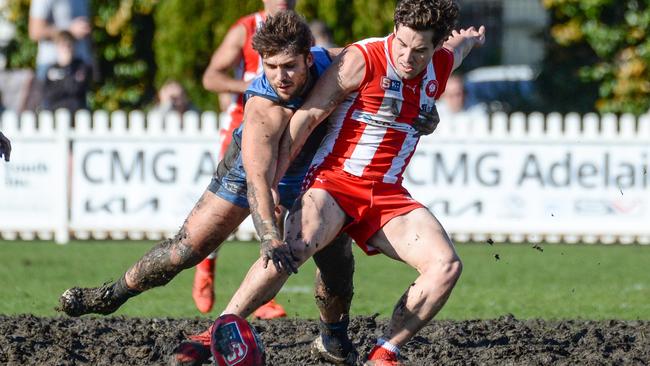 Sturt’s James Battersby and North Adelaide’s Harrison Elbrow fight for the ball in the mud at Unley Oval on Saturday. Picture: Brenton Edwards.