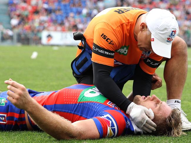 Brendan Elliot receives treatment after a hit by Hymel Hunt.