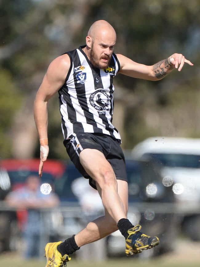 Crib Point midfielder Sam Austin boots the Magpies forward. Picture: Chris Eastman