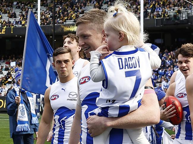 MELBOURNE, AUSTRALIA - AUGUST 19: Jack Ziebell of the Kangaroos runs out with his daughter during the round 23 AFL match between Richmond Tigers and North Melbourne Kangaroos at Melbourne Cricket Ground, on August 19, 2023, in Melbourne, Australia. (Photo by Daniel Pockett/Getty Images)