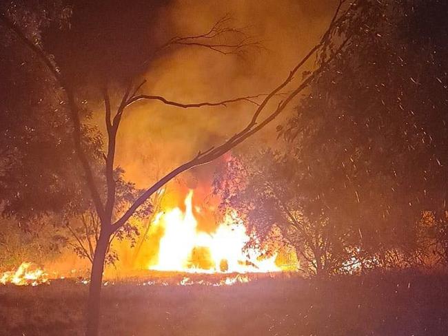 A car burning on dry grass and near power lines in Dubbo.