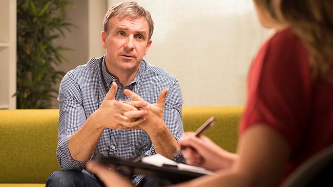 Mature man in therapy explains to therapist