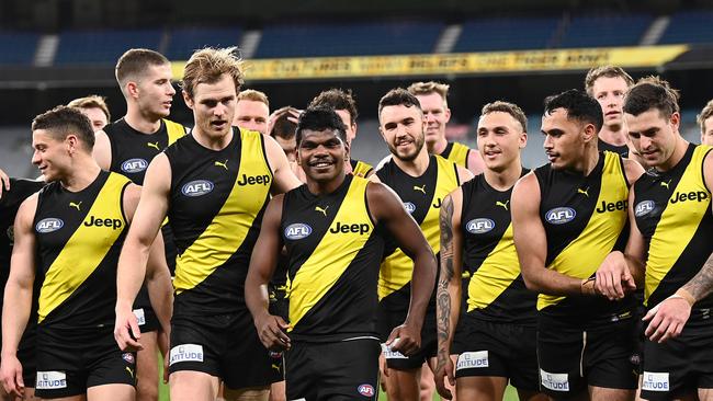 MELBOURNE, AUSTRALIA – AUGUST 07: Maurice Rioli of the Tigers is congratulated by teammates after playing in his first game during the round 21 AFL match between Richmond Tigers and North Melbourne Kangaroos at Melbourne Cricket Ground on August 07, 2021 in Melbourne, Australia. (Photo by Quinn Rooney/Getty Images)