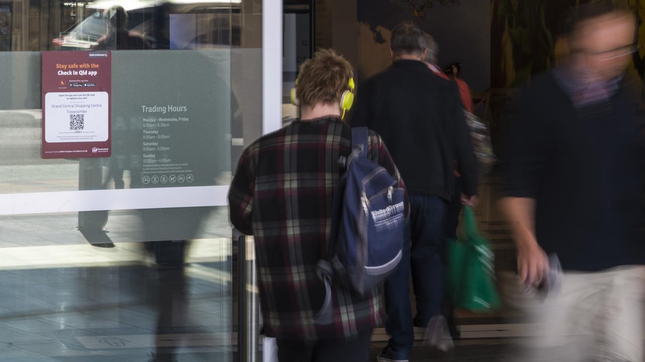 Shoppers walking past a QR check in code in the Toowoomba CBD. Picture: Kevin Farmer