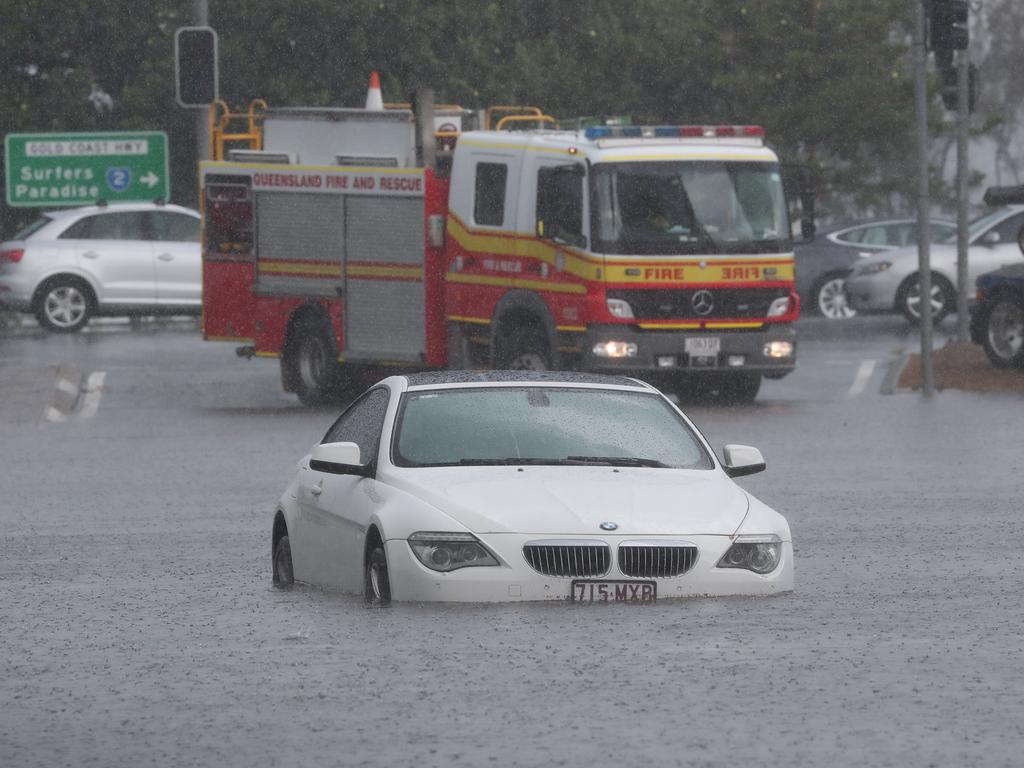 A car is flooded on Queen St in Southport after a storm lashes the Gold Coast. Picture: Jason O'Brien