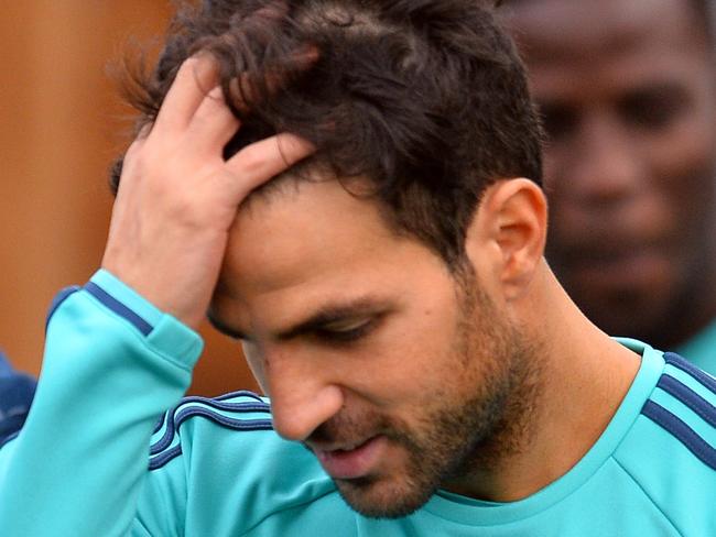 Chelsea's Spanish midfielder Cesc Fabregas (C) attends a training session on the eve of a UEFA Champions League, group G football match against Porto at Chelsea's training ground in Cobham, south west London on December 8, 2015. AFP PHOTO / GLYN KIRK