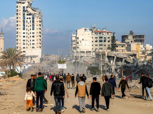 Displaced people arrive in Gaza City after crossing the crossing the Netzarim corridor from the southern Gaza Strip along Gaza's coastal al-Rashid Street. Picture: AFP