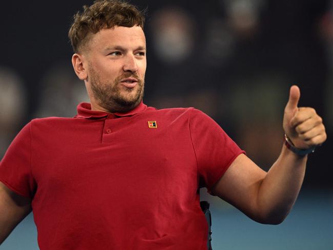 Australia's Dylan Alcott, the men's quad wheelchair singles runner-up and current Australian of the Year, reacts to the crowd after a speech ahead of the men's singles semi-final match between Russia's Daniil Medvedev and Greece's Stefanos Tsitsipas on day twelve of the Australian Open tennis tournament in Melbourne on January 28, 2022. (Photo by MICHAEL ERREY / AFP) / -- IMAGE RESTRICTED TO EDITORIAL USE - STRICTLY NO COMMERCIAL USE --