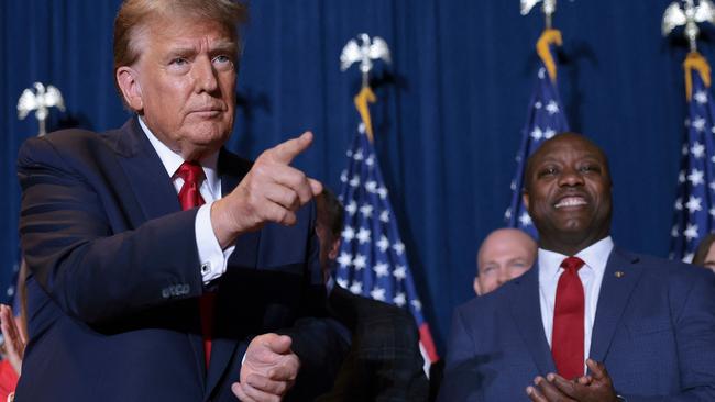 Donald Trump shares the stage with Senator Tim Scott, who would help the former president with black and Hispanic communities. Picture: Getty Images/AFP