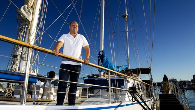 Jason Nicholls standing with one of his vessels of Tallship. 