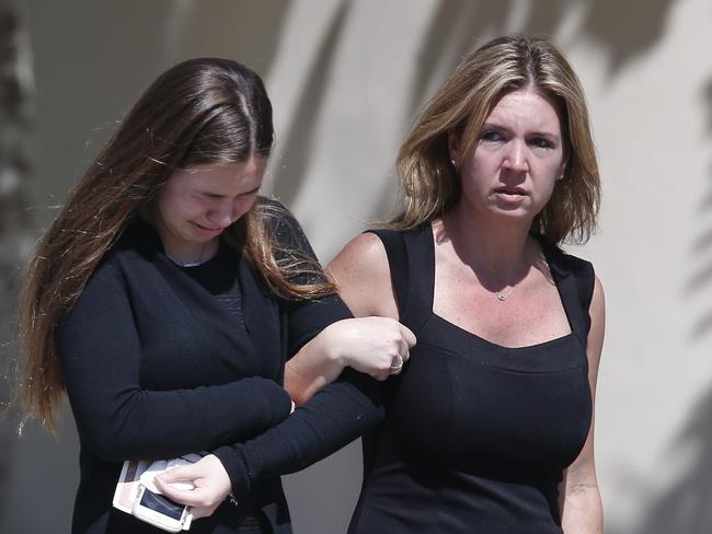 A young girl and a woman embrace as they leave a funeral service for Alyssa Alhadeff at the Star of David Funeral Chapel in North Lauderdale. Picture: AP