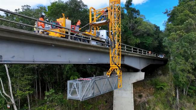 Roadtek employees work on the underside of the Barron River bridge at Kuranda. Picture: TMR