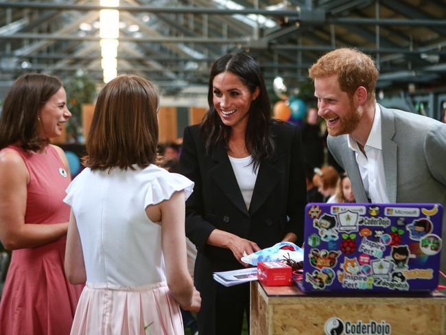 The personal touch. Meghan and Harry (at right) meet locals during a trip to Dublin, Ireland, in July this year. Picture: Jimmy Rainford/Getty Images