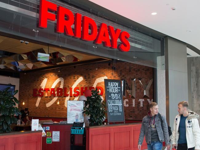 Shoppers pass by the entrance to a TGI Friday's Inc. restaurant in Moscow, Russia, on Friday, Sept. 27, 2019. McDonalds Corp. has selected Beyond Meats faux-meat patties for a plant-based burger test in Canada.  Photographer: Andrey Rudakov/Bloomberg via Getty Images