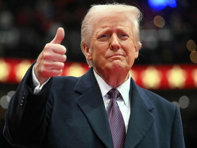 TOPSHOT - US President Donald Trump gives a thumb's up as he arrives for the inaugural parade inside Capital One Arena, in Washington, DC, on January 20, 2025. (Photo by Jim WATSON / AFP)