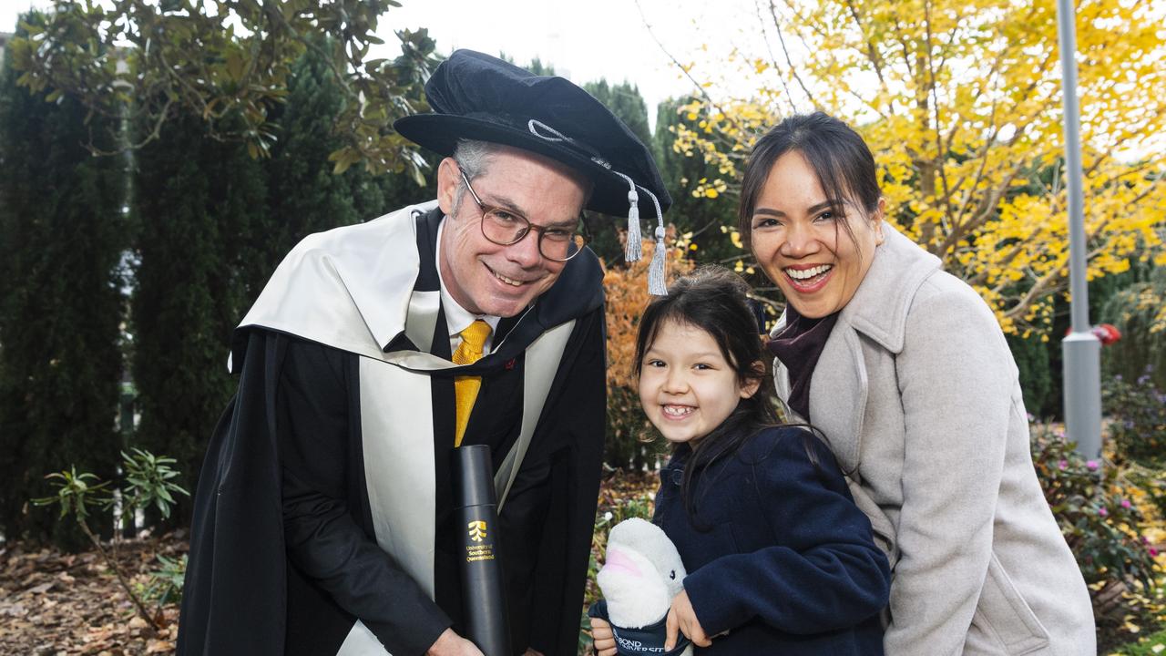 Doctor of Business Administration graduate Todd Rogers with daughter Lucy Rogers and wife Van Nguyen at a UniSQ graduation ceremony at The Empire, Tuesday, June 25, 2024. Picture: Kevin Farmer