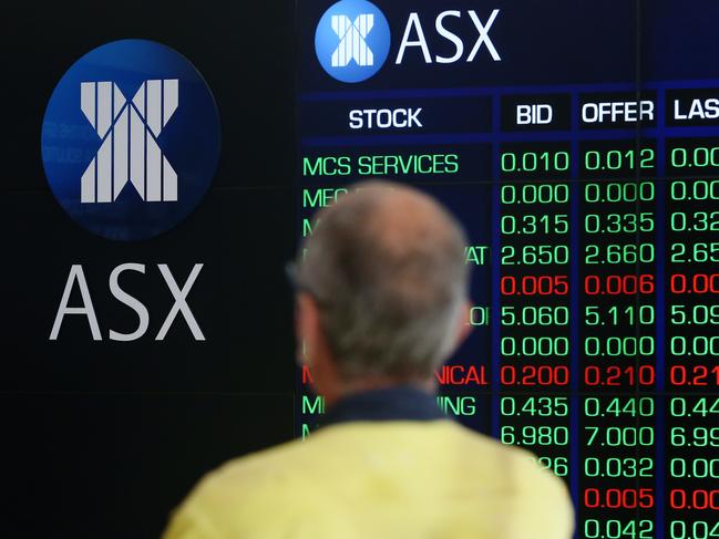 SYDNEY, AUSTRALIA - MARCH 16: A man looks at an electronic board displaying stock information at the Australian Securities Exchange, operated by ASX Ltd. on March 16, 2020 in Sydney, Australia. The ASX dropped more than 7 per cent at opening of trade on Monday as concerns over the COVID-19 fuels further travel restrictions. Strict new border measures to contain the spread of COVID-19 have come into effect Monday, requiring all overseas arrivals to Australia to self-isolate for 14 days. Australia currently has 300 confirmed cases of coronavirus while five people have died  four in NSW and one in Queensland. (Photo by Brendon Thorne/Getty Images)