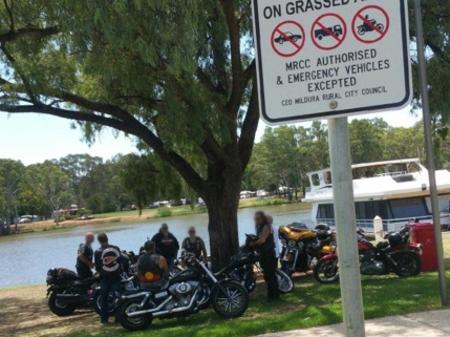 An iPhone photograph taken by police during the Mildura operation. The sign in the foreground shows the motorbikes are parked illegally, allowing fines to be issued.