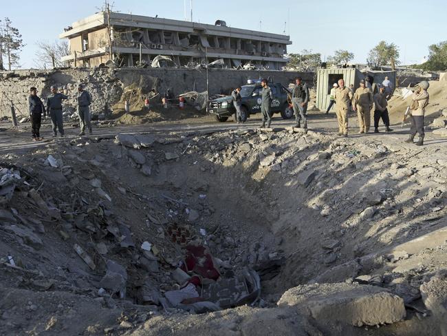 Security forces stand next to a crater created by massive explosion in front of the German Embassy in Kabul, Afghanistan, Wednesday, May 31, 2017. The suicide truck bomb hit a highly secure diplomatic area of Kabul killing scores of people and wounding hundreds more. (AP Photos/Rahmat Gul)