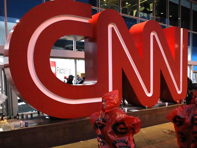 (FILES) In this file photo fans walk past the CNN Center en route to the CFP National Championship presented by AT&T between the Georgia Bulldogs and the Alabama Crimson Tide at Mercedes-Benz Stadium on January 8, 2018 in Atlanta, Georgia. - US telecommunications firm AT&T announced on May 17, 2021 a merger between its WarnerMedia unit -- which owns CNN and HBO -- and Discovery media, creating a streaming giant that could compete with Netflix and Disney+. When the deal is finalized, AT&T will receive $43 billion and AT&T's shareholders will take stock representing 71 percent of the new company, with Discovery shareholders owning 29 percent. (Photo by Christian Petersen / GETTY IMAGES NORTH AMERICA / AFP)