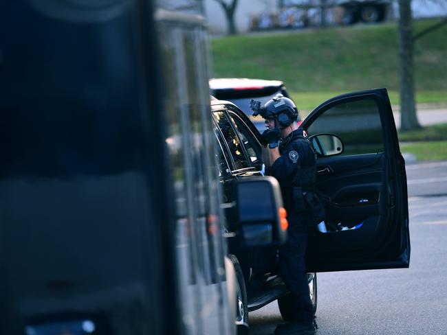 A police officer in tactical gear waits outside as President-elect Joe Biden arrives at Delaware Orthopaedic Specialists. Picture: AFP