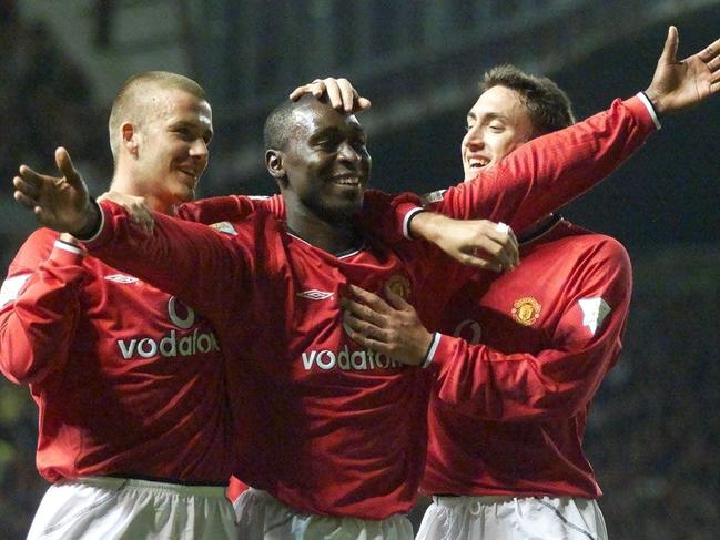 Manchester United's Andy Cole (C) celebrates with teammates David Beckham (L) and Jonathan Greening after scoring against Bradford City during an FA Premier league soccer match at Old Trafford in Manchester 05/09/2000.