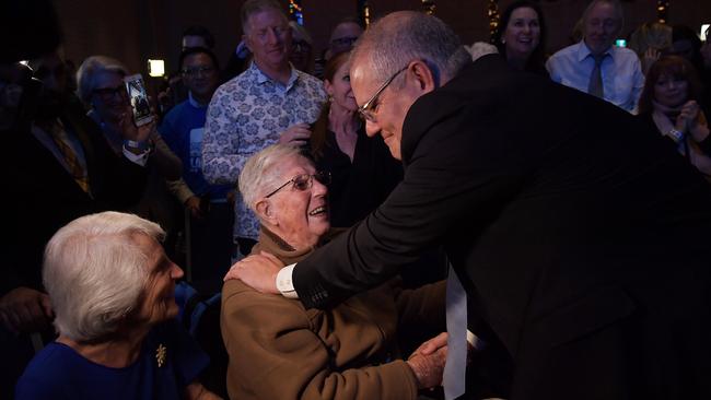 Mr Morrison greets his parents after claiming victory in Sydney. Picture: Getty Images