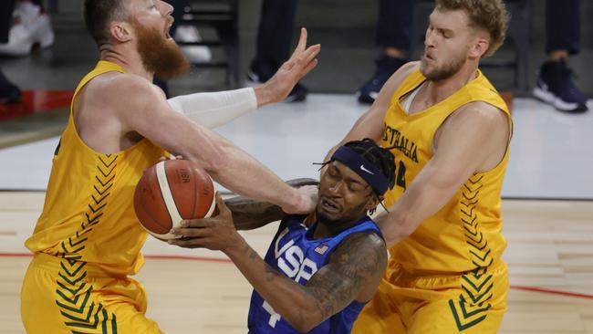 LAS VEGAS, NEVADA - JULY 12:  Bradley Beal #4 of the United States drives into Aron Baynes #12 of the Australia Boomers as Jock Landale #34 of the Boomers defends during an exhibition game at Michelob Ultra Arena ahead of the Tokyo Olympic Games on July 12, 2021 in Las Vegas, Nevada.  (Photo by Ethan Miller/Getty Images)