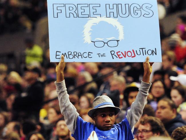This photo taken March 25, 2016, shows a Devonte Hart holding up a sign as then Democratic presidential candidate Bernie Sanders addressed the crowd during a rally in Portland, Oregon. Picture: AP