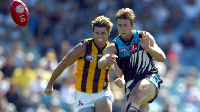 Shane Crawford chasing Stuart Dew, during Dew’s stint with Port Adelaide. The two played together for Hawthorn, but could’ve teamed up in South Australia had things gone differently.