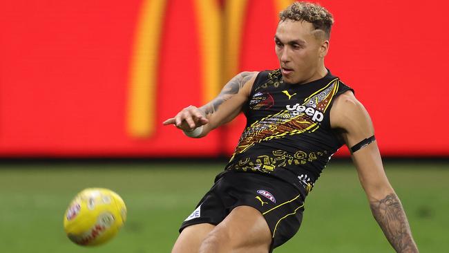 PERTH, AUSTRALIA - JUNE 05: Shai Bolton of the Tigers kicks on goal during the round 12 AFL match between the Essendon Bombers and the Richmond Tigers at Optus Stadium on June 05, 2021 in Perth, Australia. (Photo by Paul Kane/Getty Images)