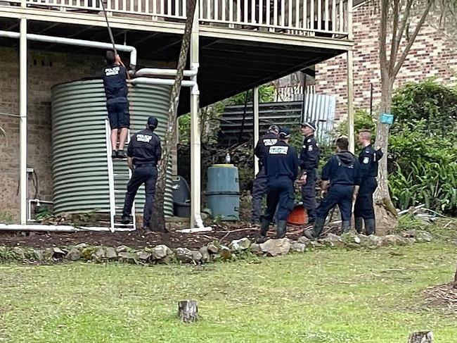 KENDALL, AUSTRALIA - NewsWire Photos - NOVEMBER 24, 2021. Police look at a water tank at the house William Tyrrell went missing from near Kendall. Supplied Picture: NCA NewsWire / Peter Lorimer.
