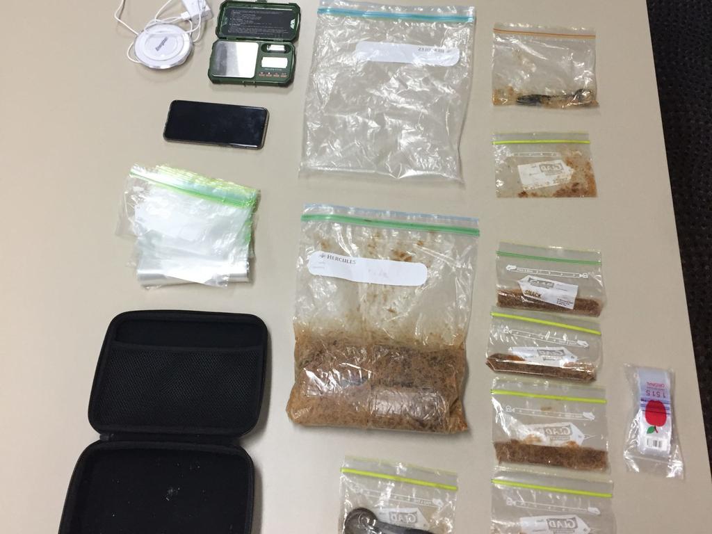 Drugs and items uncovered during a police search in Airlie Beach on Thursday. Police allege more than 1kg of MDMA was uncovered.