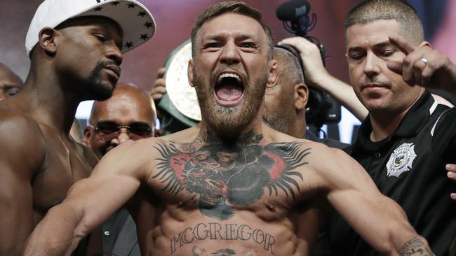 Conor McGregor weighs in vs Floyd Mayweather during August.