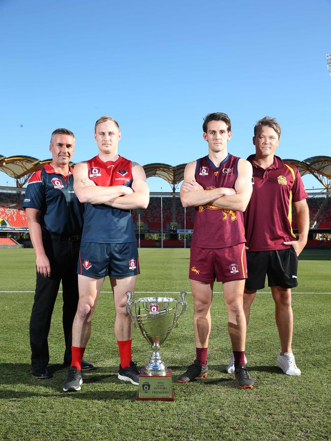 The coaches and captains of Surfers Paradise Demons and Palm Beach Currumbin ,left to right, Brad Moore, Brody Haberfield, Stephen Thynne, and Jess Sinclair, with the QAFL cup at Metricon Stadium. Picture Glenn Hampson