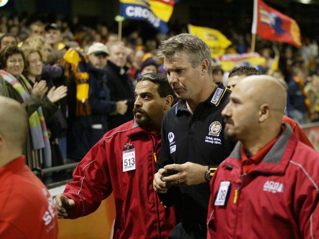 Being escorted by security guards after a game against Adelaide.