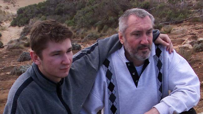 Vadim Volkov with his father Victor looking at wreckage of their fishing boat at Southend near Beachport in August 2002.