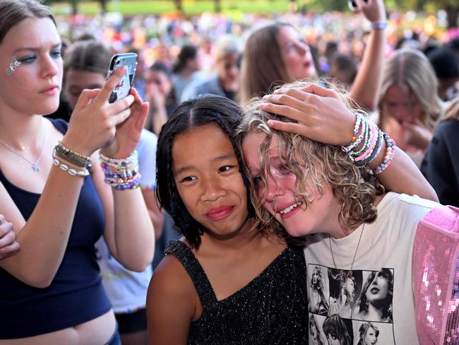 Ticketless fans for US singer Taylor Swift stand outside at the MCG.