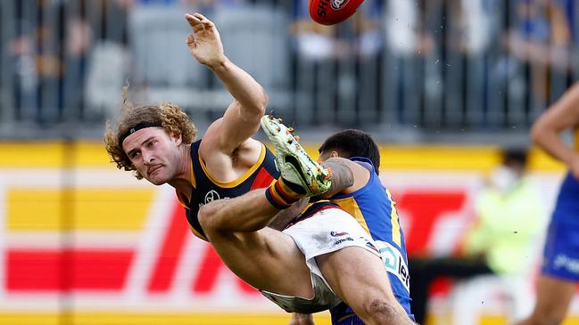 Sam Berry gets a kick away in a heavy Tim Kelly tackle. Picture: Paul Kane/Getty Images