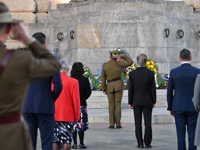 SA Governor Hieu Van Le (Centre in dark suit) surrounded by a handful of soldiers and other dignitaries at this morning’s Adelaide Anzac Day service. Photo: AAP Image/David Mariuz.